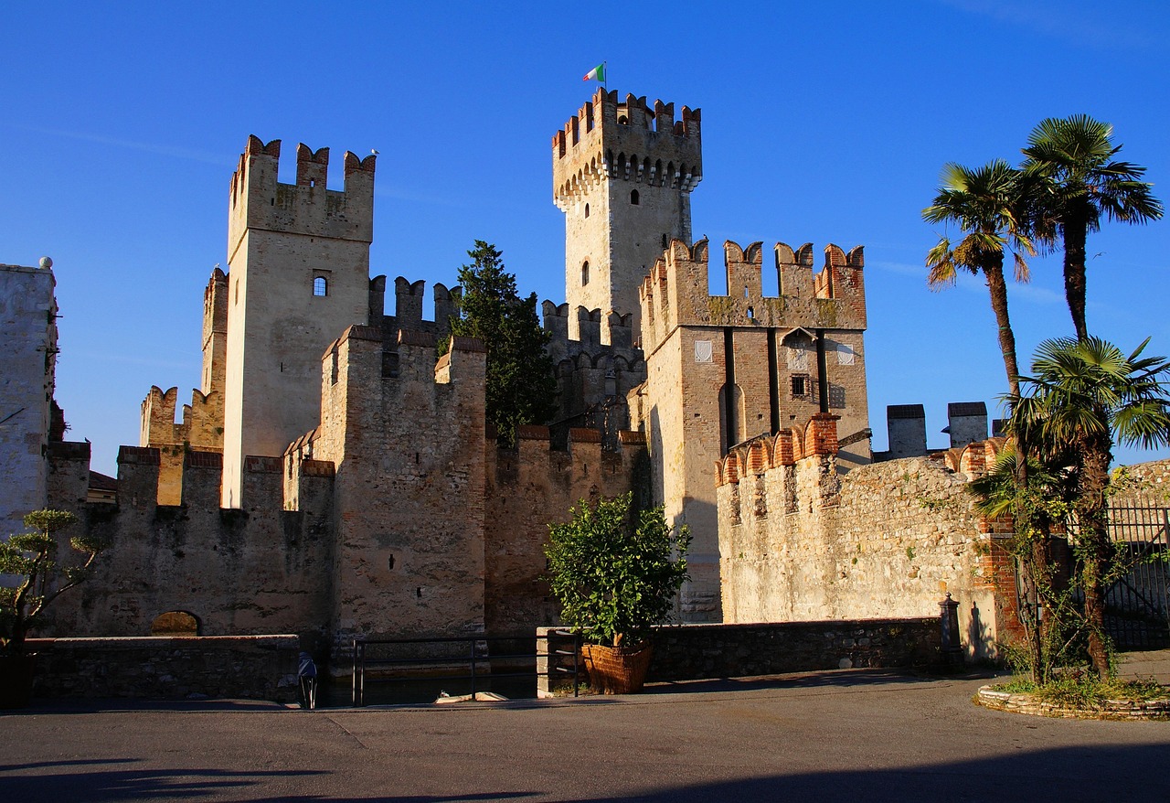 Castello di Sirmione, rocca affacciata sul Lago di Garda, circondata da acque blu e natura.